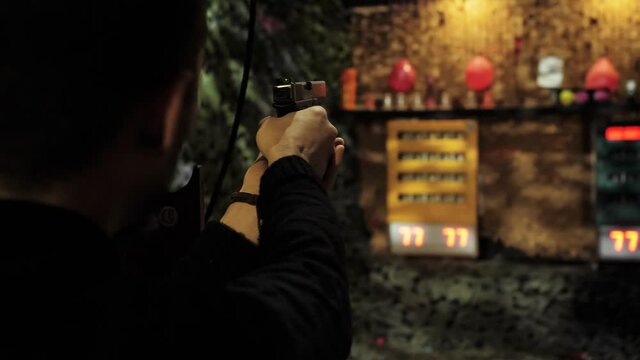 man shoots at a shooting range with a gun