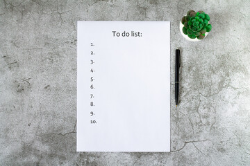 To do list on blank page top view on light gray stone background