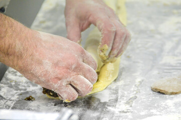 A chef preparing maultaschen or traditional german dumplings at a restaurant kitchen