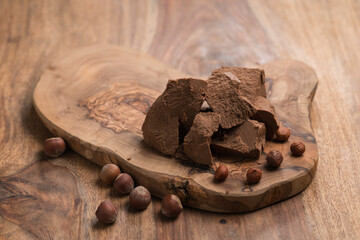 Gianduja chunks on wood board background
