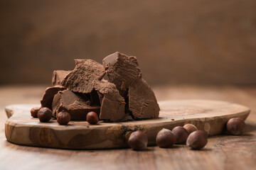 Gianduja chunks on wood board background