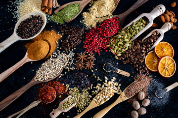 Many spices and herbs on the dark background table - obrazy, fototapety, plakaty