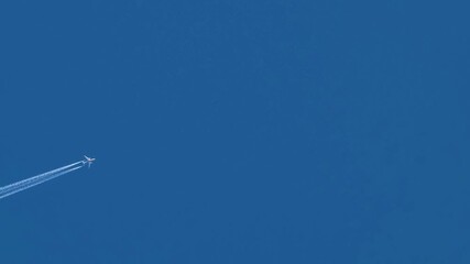 Jet plane flies high in the blue sky