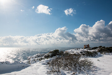 Uluzzo tower after a exceptional snowfall, Salento, Italy