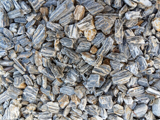 Natural stone background. Numerous pieces of granite fill the whole picture