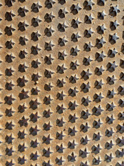 Metal background. View of a rusty metal plate with numerous small stars