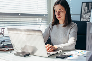 Woman busy working on laptop at office