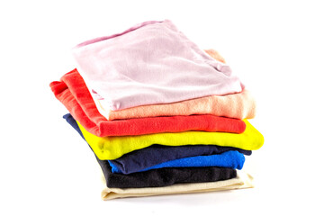 A stack of multicolored knitwear, t-shirts, stacked vertically, isolated on a white background