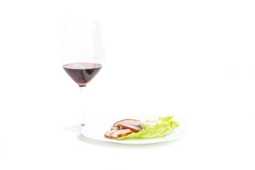 Salad, smoked meat and red wine on a white isolated background. Minimalistic and refined lunch of separate fractional nutrition. selective focus on leaves of chinese cabbage