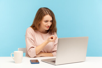 Come here! Happy beautiful woman with friendly smile making beckoning gesture while talking on...