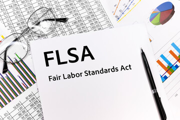 text FLSA fair labor standards act written on the sheet. pen, glasses, documents, graphics.