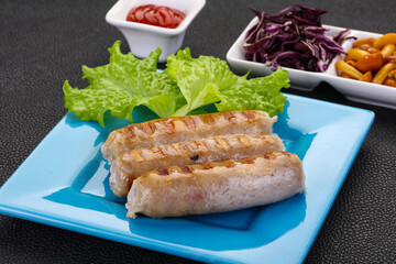 Grilled sausages served mushrooms and cabbage