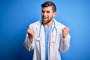 Young blond doctor man with beard and blue eyes wearing white coat and stethoscope celebrating surprised and amazed for success with arms raised and open eyes. Winner concept.