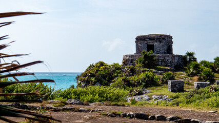 Temple and tropical nature under the bright sunlight situated in the ancient Mayan city of Tulum in Quintana Roo, Mexico.