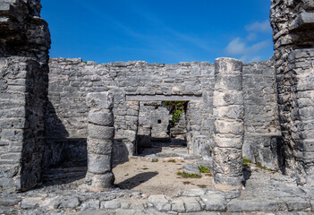 Old stone entrance of a building in ruins situated in the ancient Mayan city of Tulum in Quintana Roo, Mexico.