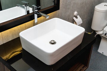 The photo of a sink and mirror in a bathroom