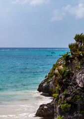 Beautiful view of the Ocean with distant boats from the ancient Mayan city of Tulum in Quintana Roo, Mexico.