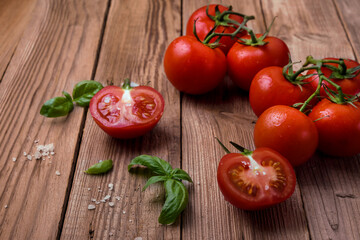Fresh tomatoes with basil on rustic background.