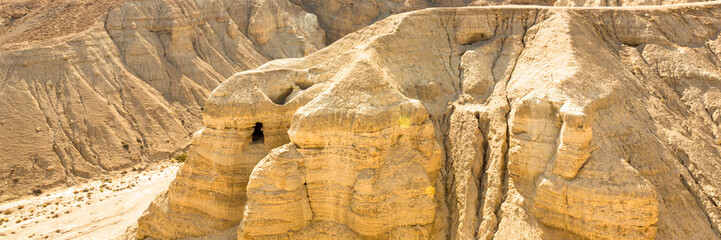 Caves of Qumran, manuscripts of the Dead Sea. Web banner in panoramic view.