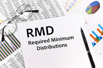 RMD on white paper. Glasses and black pen on against the background of documents. Financial bookkeeping, Accounting Concept. Top view.