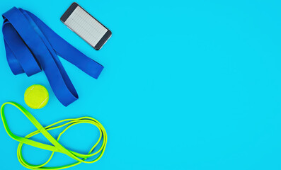 Set of multi-colored elastic rubber resistance bands on a bright blue background, layout. Equipment for sports and home workout, smartphone with tracker, top view with copy space.