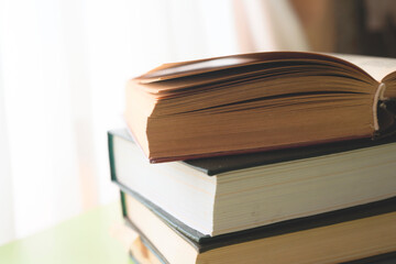 Open book, hardback books on bright colorful background.