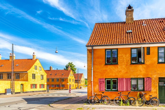 Old yellow houses of Nyboder district with bicycles. Old Medieval district in Copenhagen, Denmark
