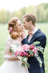 Wedding ceremony. The groom kisses the bride. Beautiful couple.