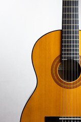 Acoustic guitar placed on the right
side in portrait format on a light background