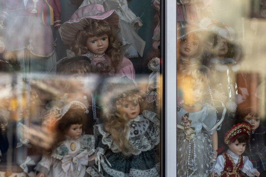 Beautiful vintage dolls in showcase. Soft focus, glare glass.