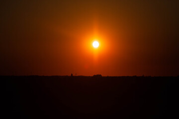 Fototapeta na wymiar Golden fire sunset above the horizon.