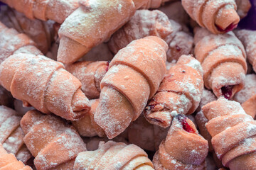 Freshly baked delicious croissants sprinkled with powdered sugarFreshly baked delicious croissants sprinkled with powdered sugar