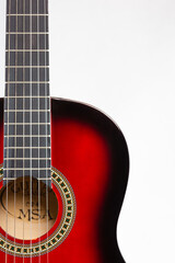 Acoustic guitar placed on the left
 side in portrait format on a light background