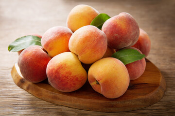 Naklejka na ściany i meble fresh peaches on a wooden table