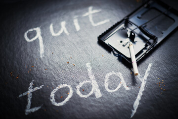 Stop smoking today concept. Mousetrap with cigarettes and the inscription- Quit today.