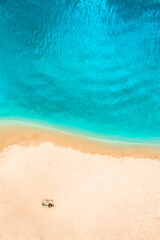 Aerial Top Drone view of a people couple on the Sand beach. Vacation sea Background. Azure Beach River water and People.