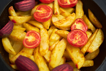 Baked potato with meat, tomatoes, beetroot in the oven.
