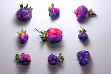 Trendy ugly food pattern fresh  violet pink strawberry on white isolated background with shadows.  Misshapen produce, food waste problem concept