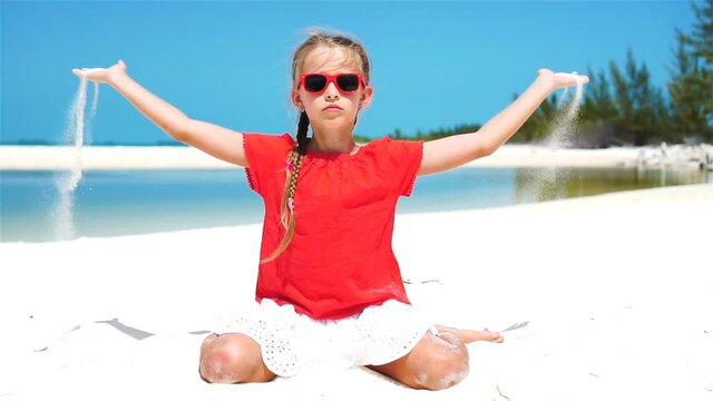 SLOW MOTION CLOSE UP: Girl playing with beautiful white sand at exotic beach