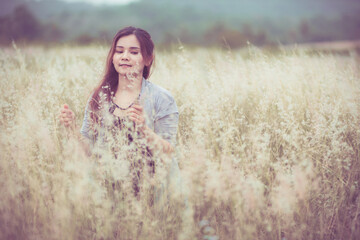 Flowers and the woman palm in the field. Lit evening sun.