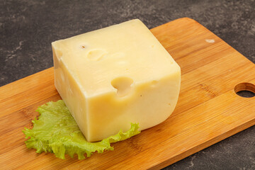 Emmental cheese over wooden board