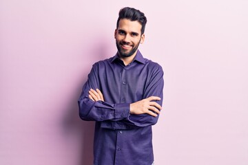 Young handsome man with beard wearing casual shirt happy face smiling with crossed arms looking at the camera. positive person.