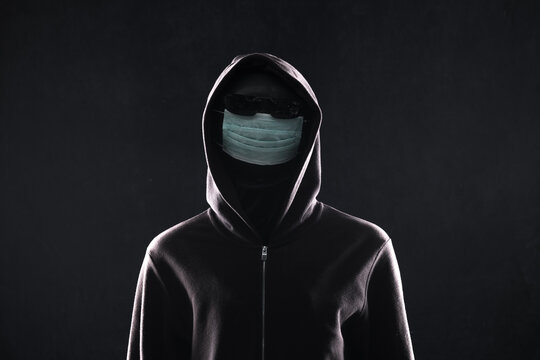 hacker in a medical mask in the hood