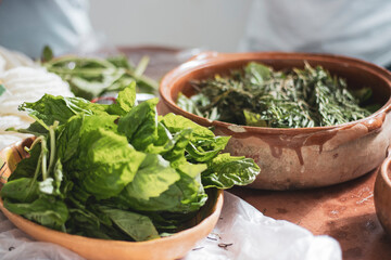 Green herbs in terracotta bowls