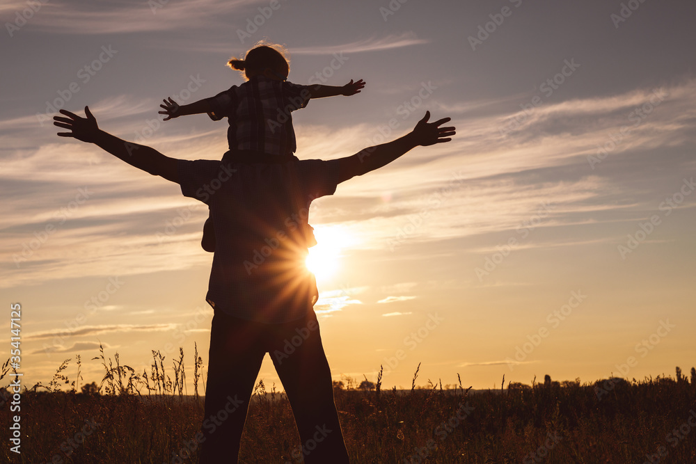 Canvas Prints father and son playing in the park at the sunset time.