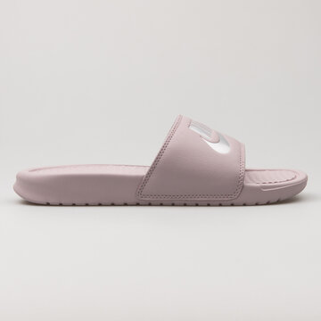 VIENNA, AUSTRIA - FEBRUARY 19, 2018: Nike Benassi JDI rose sandal on white background.