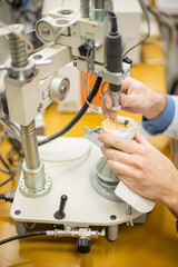 A dental technician makes partial dentures on a mechanized machine. The production of the false jaw or dental bridges using the apparatus. Close-up.
