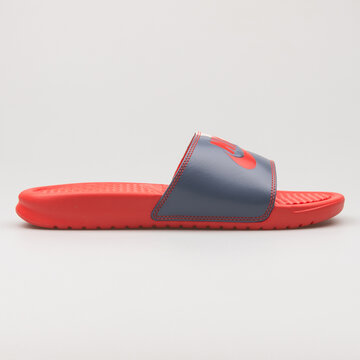 VIENNA, AUSTRIA - FEBRUARY 19, 2018: Nike Benassi JDI red and grey sandal on white background.