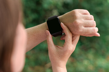 Woman wearing smart watch with mock up screen