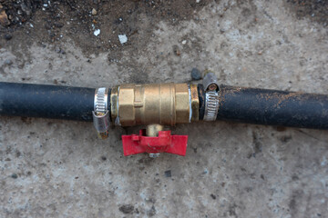 connecting water valve with blue rubber water hose.